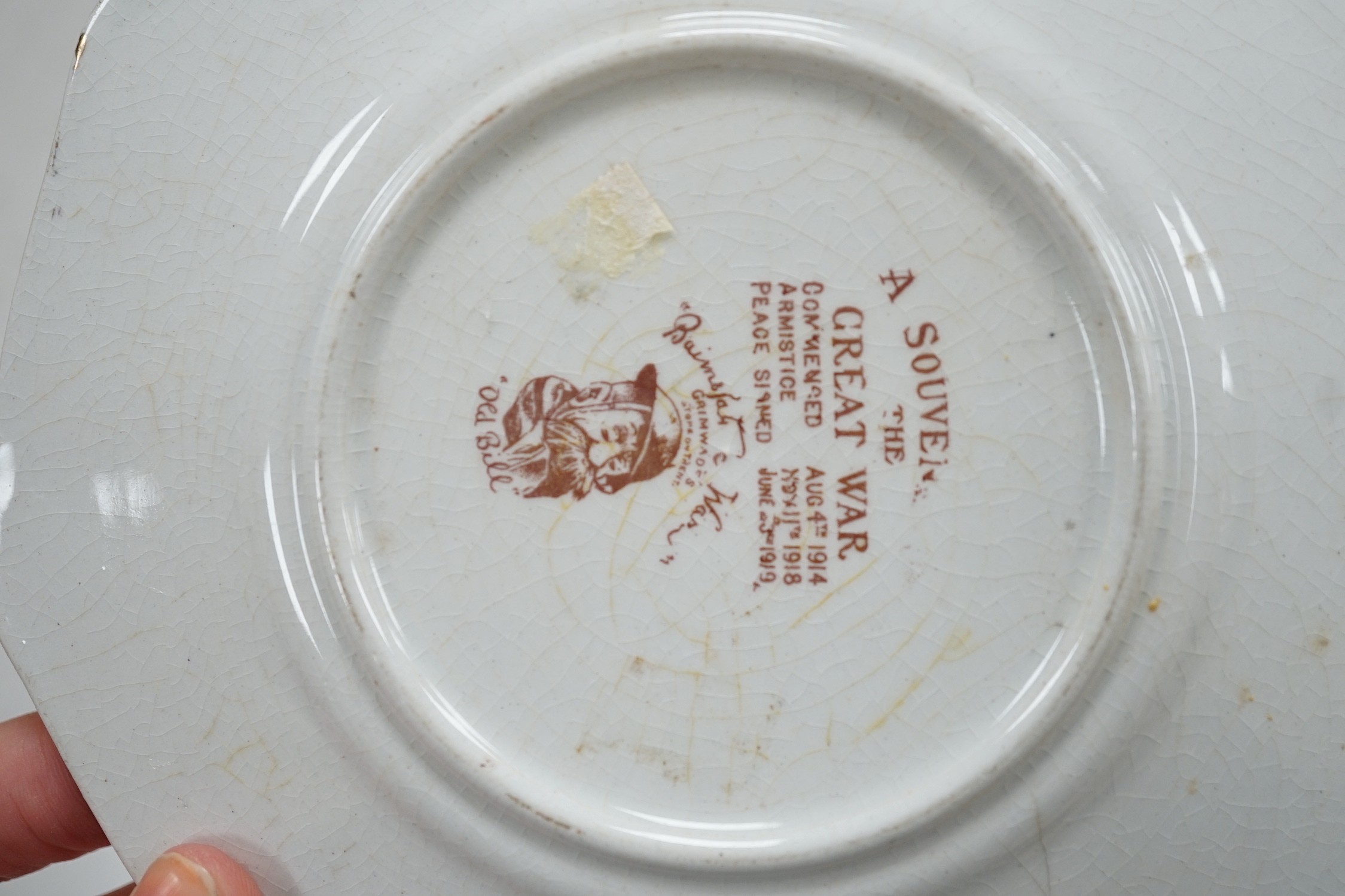WWI commemorative Grimwades ‘Old Bill’ ceramics, including a jug, a bowl, five various dishes and a moustache cup and saucer, together with two novelty character jugs and a spy card game